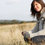 Young Woman Outdoors In Autumn Landscape