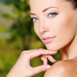 Woman stroking her fresh clean skin of face