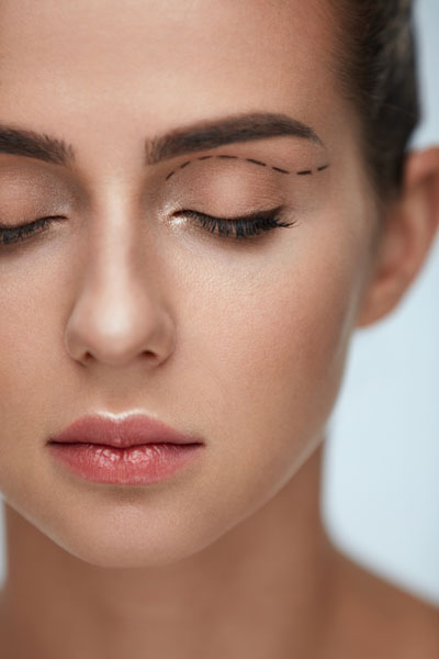 Female Face With Black Surgical Lines On Eyelids