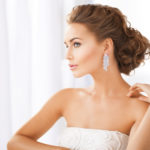 woman wearing shiny diamond earrings
