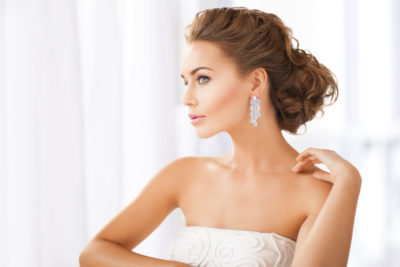 woman wearing shiny diamond earrings