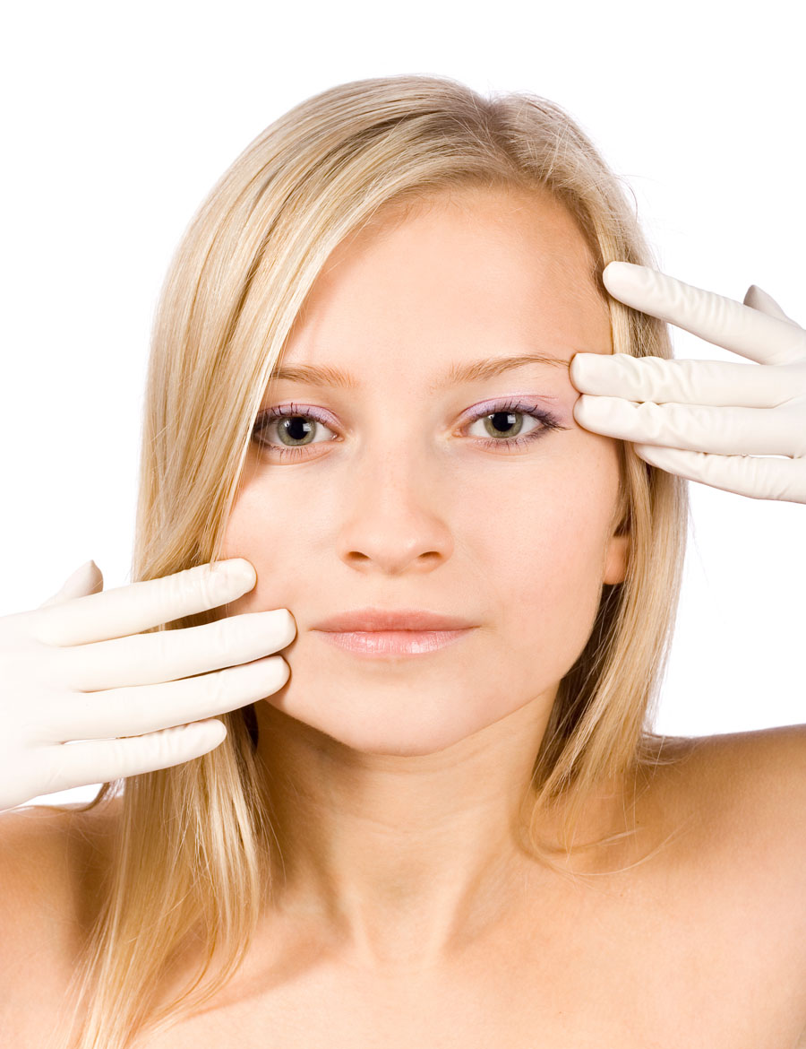 face of young blonde woman + her hands in gloves
